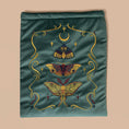 Load image into Gallery viewer, Embroidered velvet fabric with lunar moth designs on a teal background
